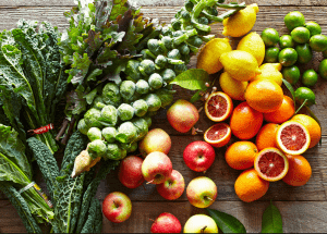 a group of fruits and vegetables on a wood surface Healthy Weight Loss Diets Newton Mearns